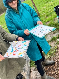 people outside in the rain with ink and paint