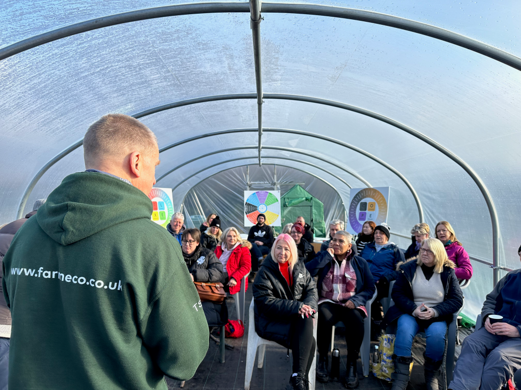 team of people listening to someone talk about their personal strength at an outdoor nature team building day